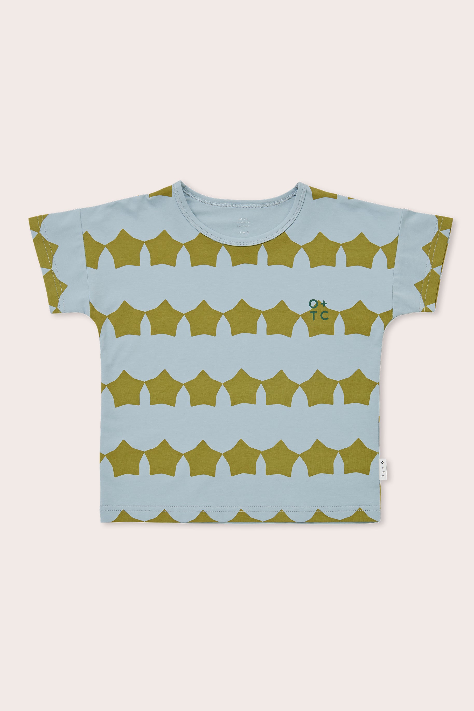 The Evergreen Supernova Relaxed Fit Tee from OLIVE + THE CAPTAIN is a premium cotton short-sleeved toddler t-shirt with a light blue base color and a repetitive pattern of golden-brown, semi-circular shapes. It features an elevated classic style, accented by a small green "OKTC" logo on the chest.