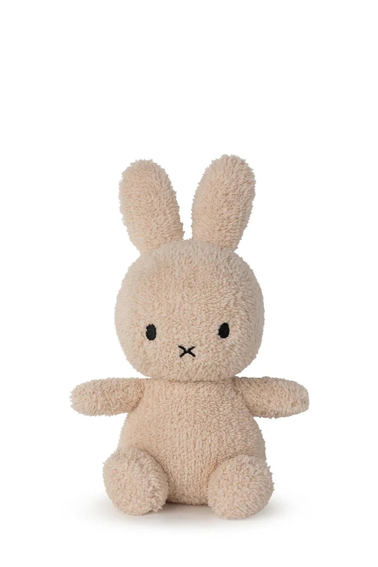 The Miffy Sitting Terry Beige 23 cm by BON TON TOYS X MIFFY is a soft plush bunny with long ears, black oval eyes, and a stitched "X" mouth—an ideal baby gift shown sitting upright against a plain white background.