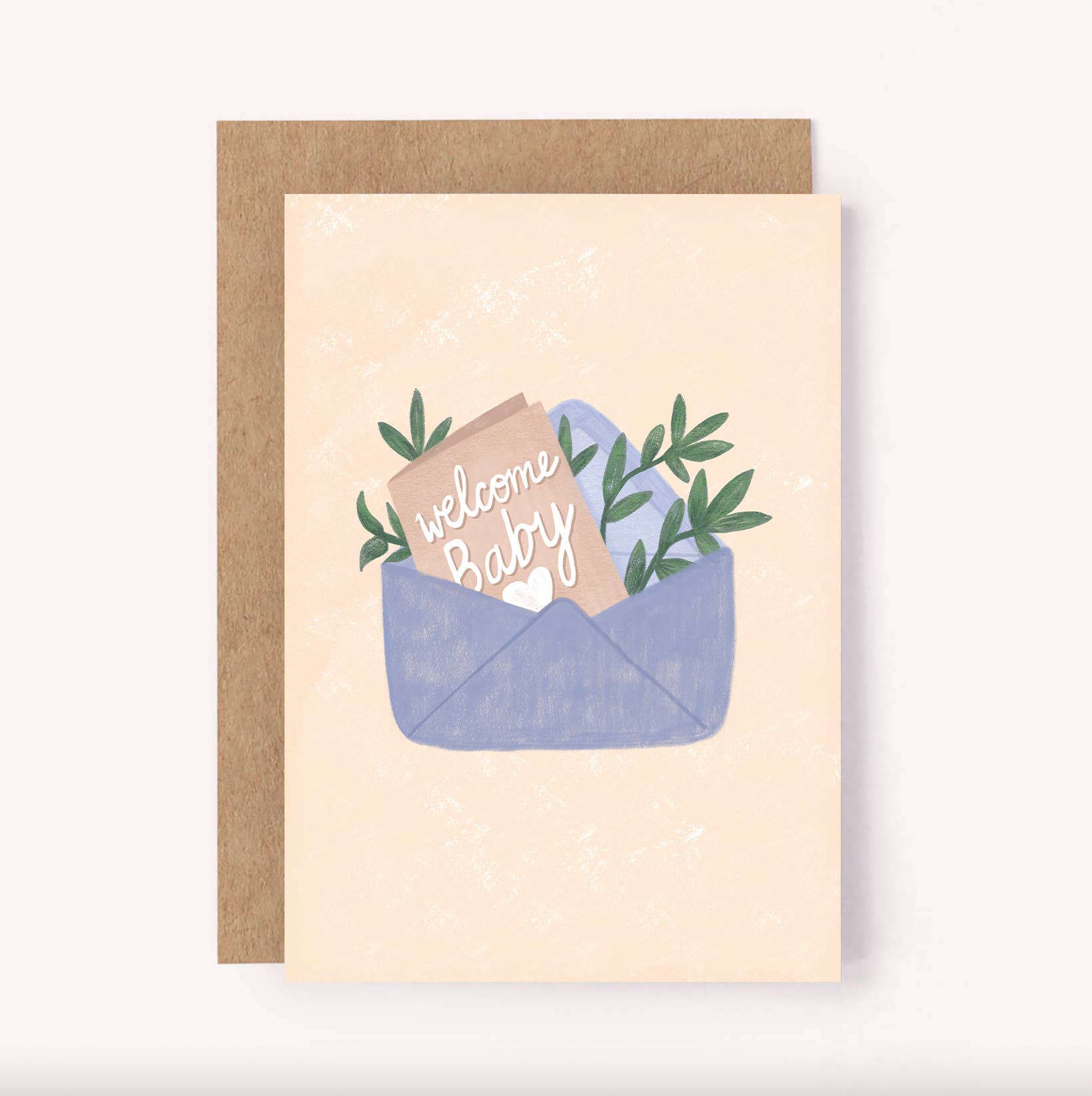 Lauren Sissons Studio presents the "Welcome Baby Card," a gender-neutral design featuring an open blue envelope with a "Welcome Baby" message and green leaves on a light beige background. It comes with a brown envelope made from recycled paper.