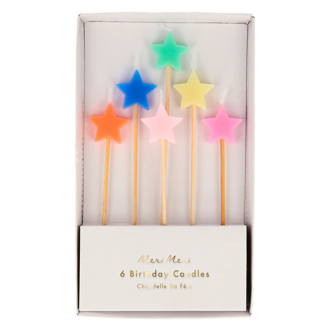 A pack of "Mixed Star Candles" by MERI MERI, featuring six vibrant colors including orange, pink, blue, green, yellow, and light pink. Perfect for celebratory cakes at birthday parties. The candles are packaged in a white box labeled: "6 Birthday Candles, Chandelle De Fée.