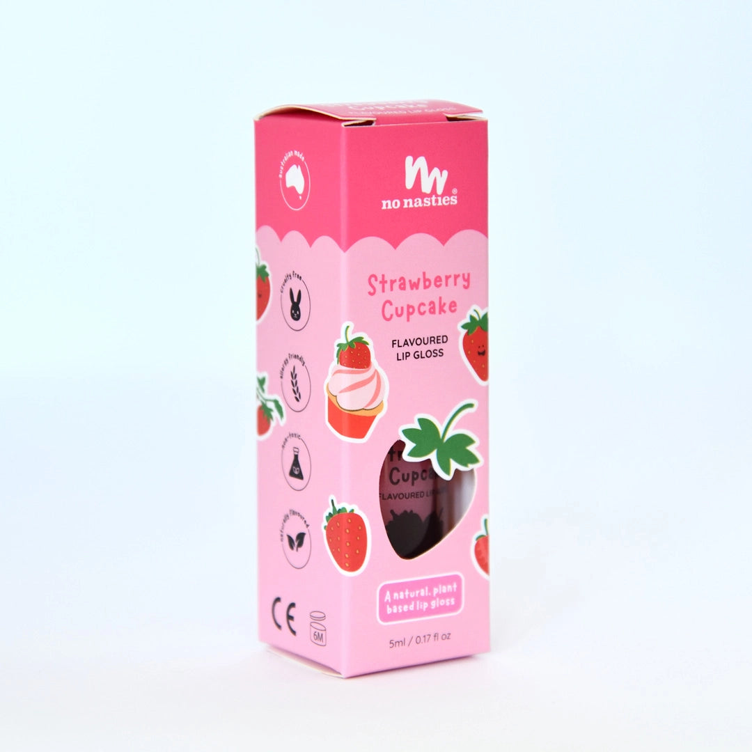 A pastel pink "NO NASTIES" Scented Scratch Off Kids Nail Polish in Strawberry Cupcake comes in a box with strawberries, cute icons, and a cupcake illustration. The packaging features a window to showcase the polish inside.