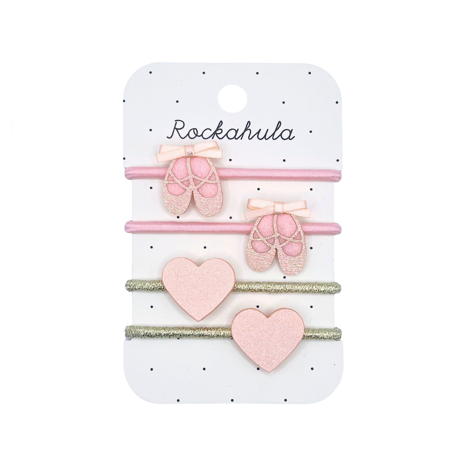 The Rockahula - Ballet Shoes Ponies by ROCKAHULA is a set of four children's hair ties on a branded card, with two ballet slippers and two pink glitter hearts crafted from soft recycled felt.