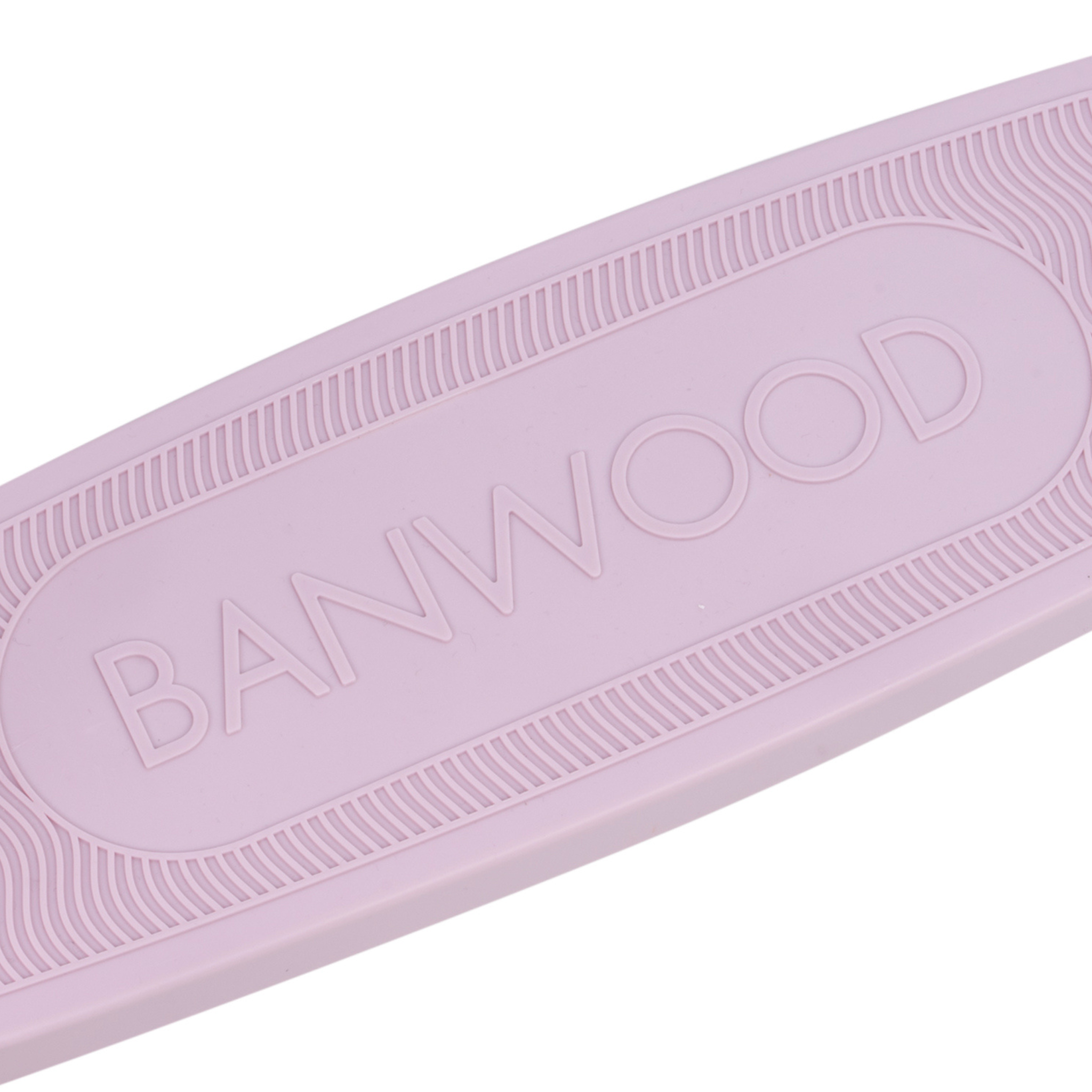 Close-up of a pink skateboard deck featuring "BANWOOD" embossed in the center, crafted sustainably with subtle edge texture lines akin to their Eco Scooter Lavender made from recycled plastic.