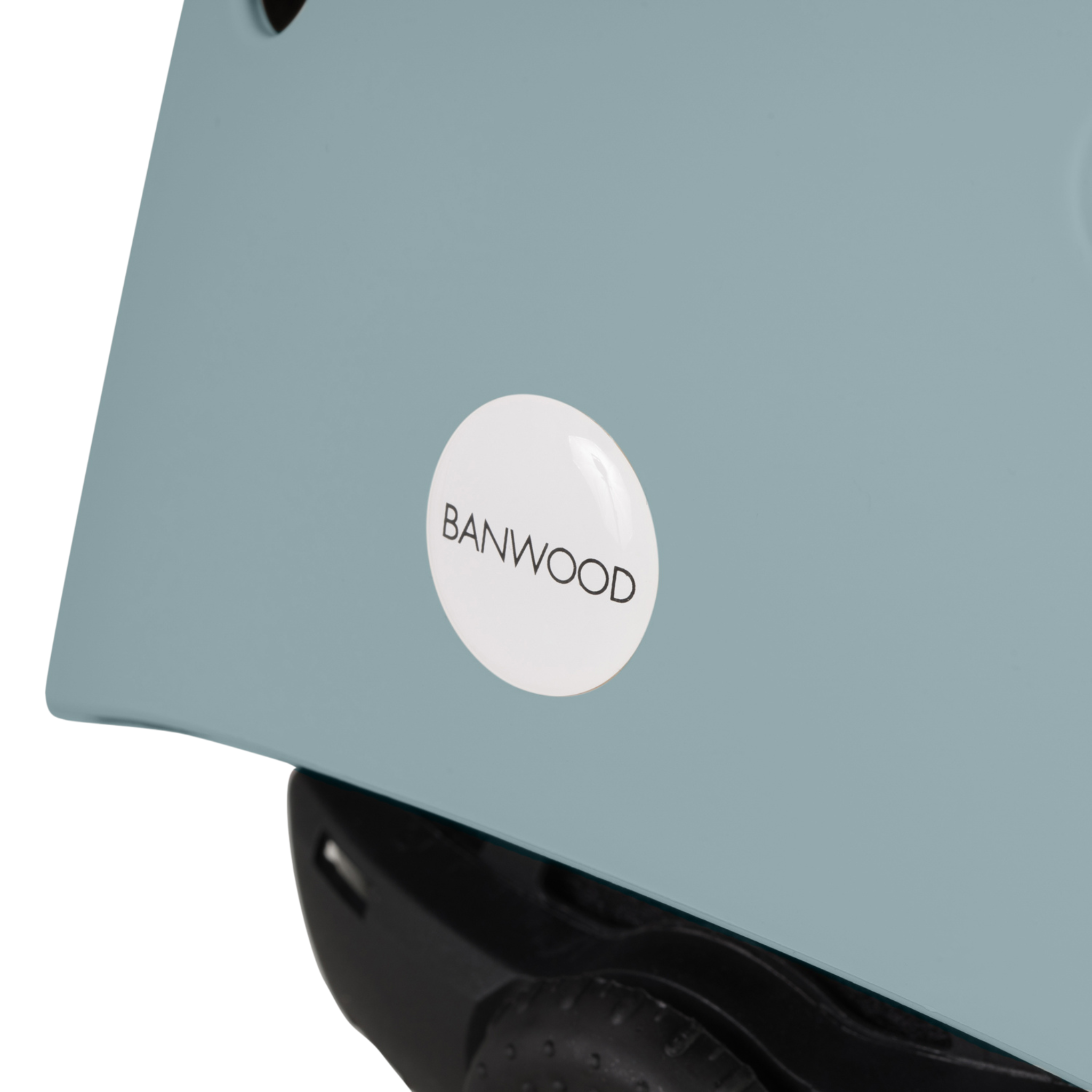 Close-up of a Teal Banwood Eco Helmet with a white BANWOOD sticker and black recycled padding for safety and sustainability.