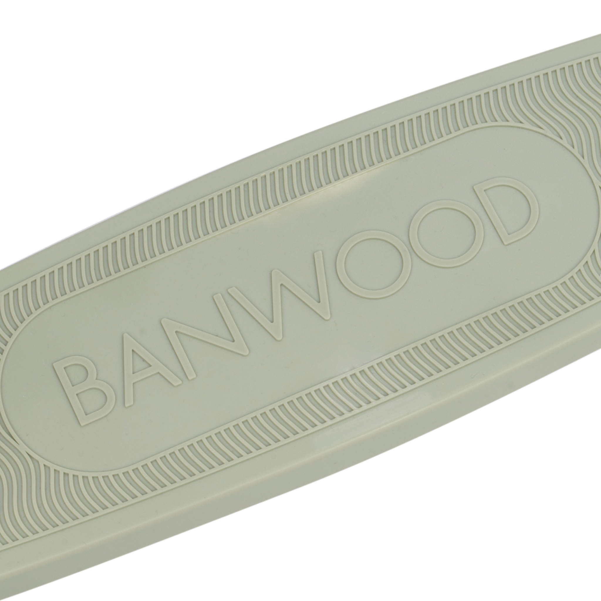 A close-up of the Banwood Eco Scooter Olive deck shows "BANWOOD" embossed at the center. Made from 100% post-consumer recycled plastic, it features parallel wavy lines in a raised design and has a light, neutral hue.