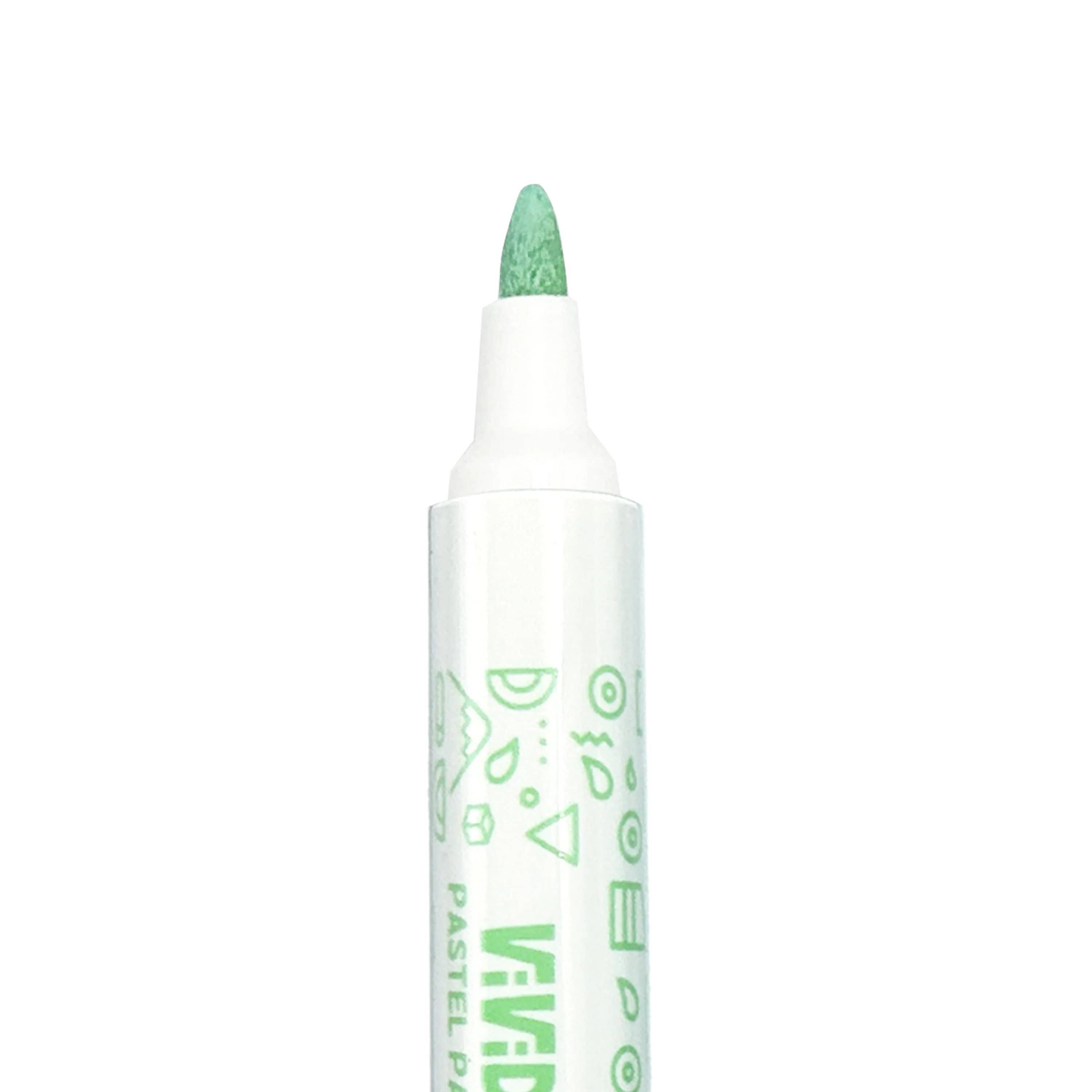 A close-up of an OOLY Vivid Pop! Water-Based Paint Marker in green with a pointed tip and geometric designs on its white barrel—part of the pastel set of 8, perfect for creative projects on various surfaces.