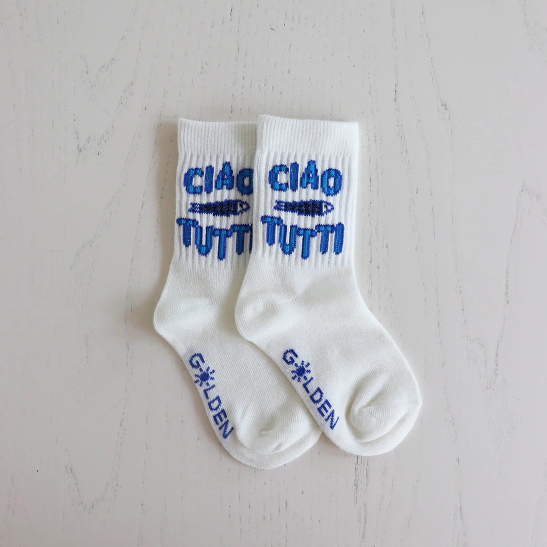 The Golden Children Ciao Tutti Pesci Socks Vanilla feature blue text, a fish illustration, "GOLDEN" by the toes, ribbed design, and reinforced toe caps—all displayed on a light surface.