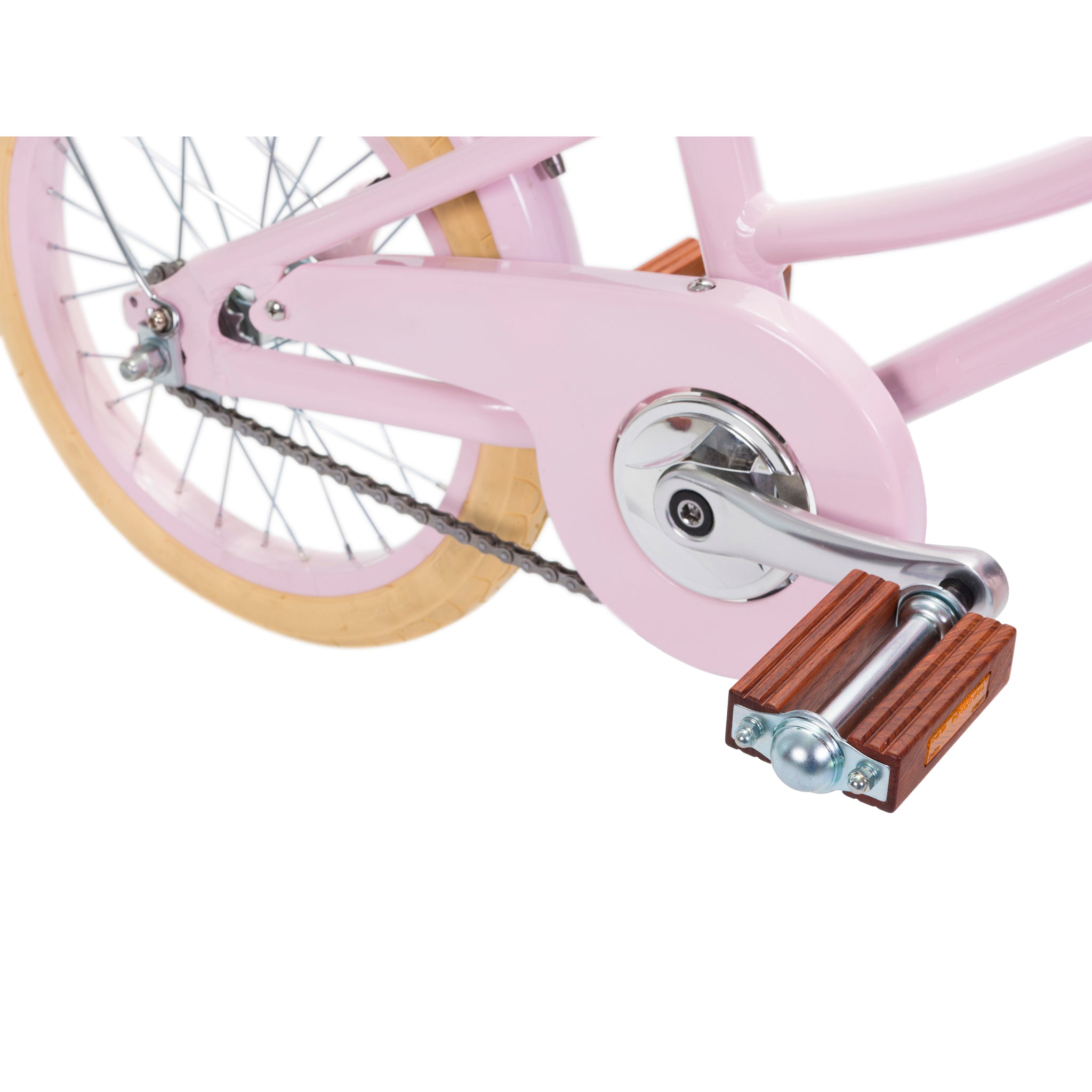 A close-up of the rear wheel of the Banwood - Classic Bicycle Pink highlights its vintage Scandinavian design, featuring a metal gear system, wooden pedal with a silver ball end, and cream tire contrasting with the pink frame. The chain is visible on the left side.