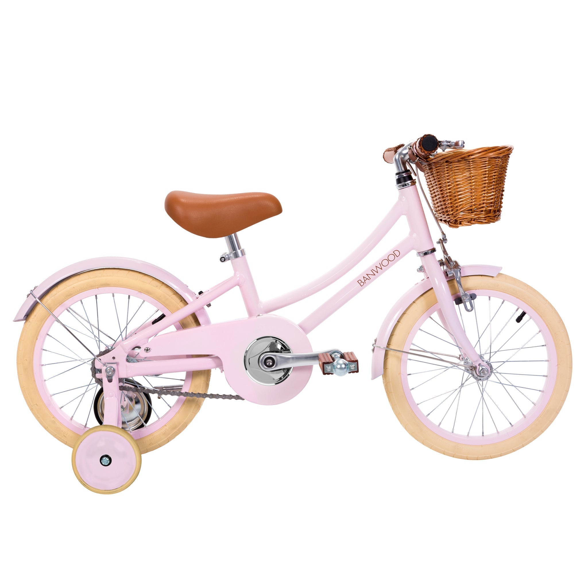 The Banwood - Classic Bicycle Pink, by BANWOOD, embodies Scandinavian design with its light pink frame and training wheels. It includes a tan leather saddle, a woven basket on the handlebars, cream-colored tires, and silver pedals for a charming look.