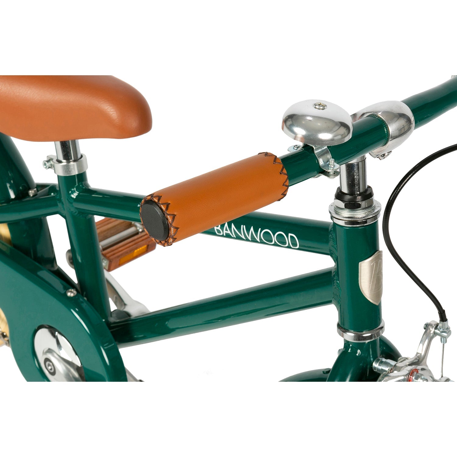Close-up of the Banwood - Classic Bicycle Green, a vintage-inspired children's bike with a brown leather seat and matching grips. It features a silver bell on the handlebar and displays the BANWOOD brand name in white on its frame.