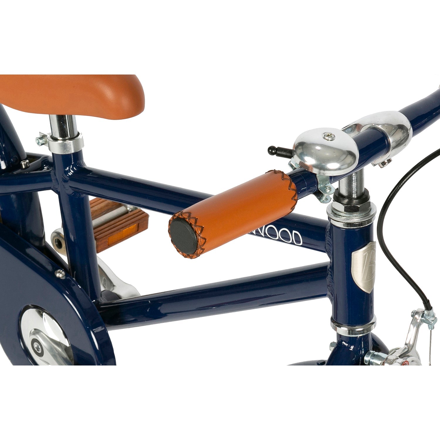 Close-up of the Banwood - Classic Bicycle Navy by BANWOOD, showcasing brown leather accents on the handlebars and seat. A silver bell adorns the handlebar, completing its vintage look against a white background.