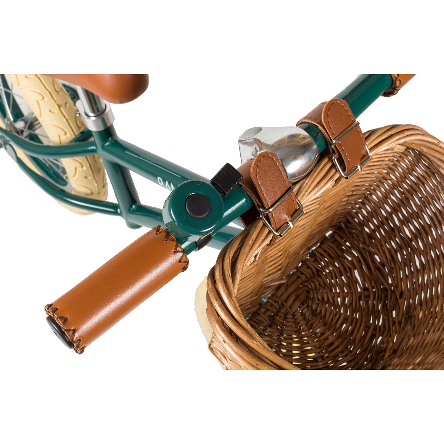The Banwood Vintage Balance Bike Dark Green by BANWOOD showcases a classic design with brown leather grips, a silver bell, and a front wicker basket. Its cream-colored tires enhance the vintage style, offering a charming and balanced ride for young cyclists.