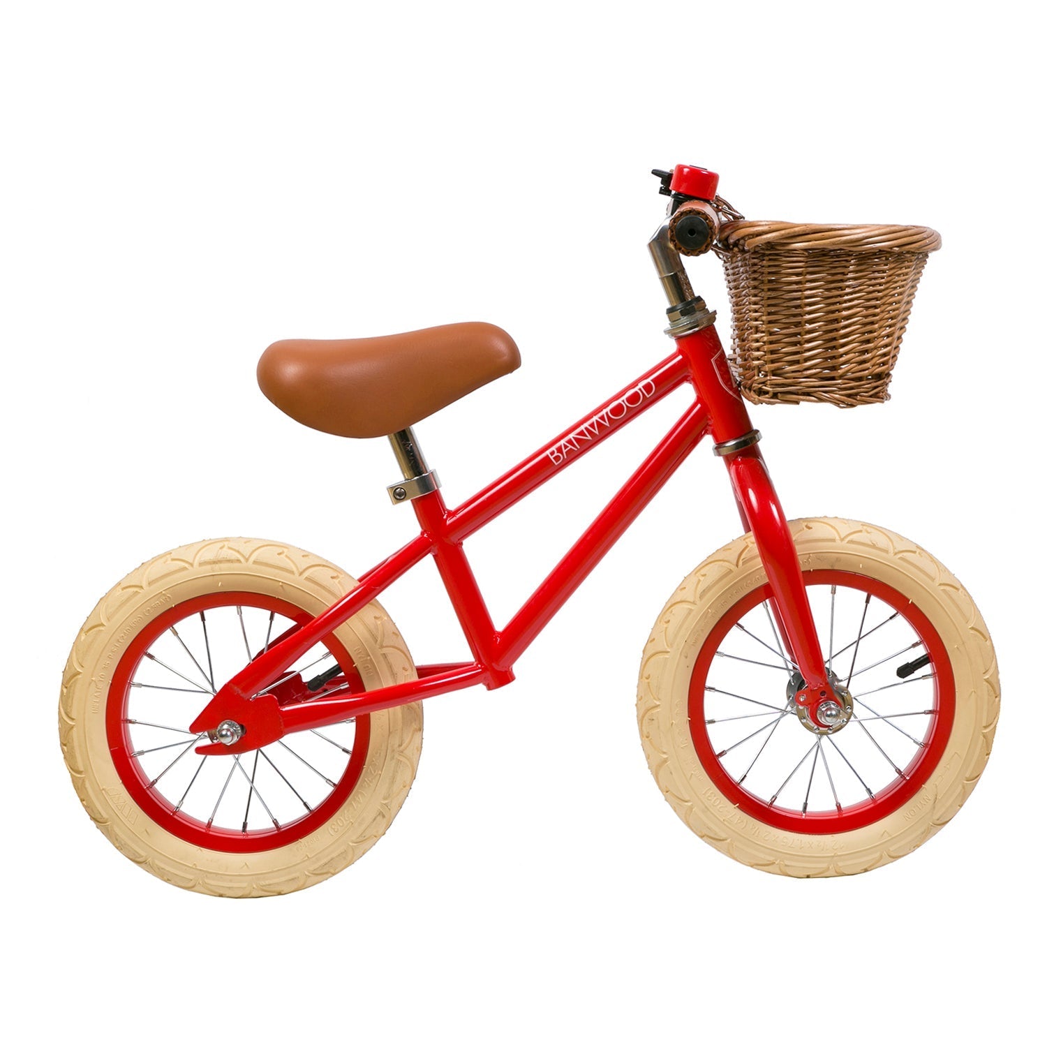 The Banwood - Vintage Balance Bike Red by BANWOOD features a child-friendly frame with beige tires, a brown seat, and a charming wicker basket on the front. Its design blends simplicity and functionality seamlessly.