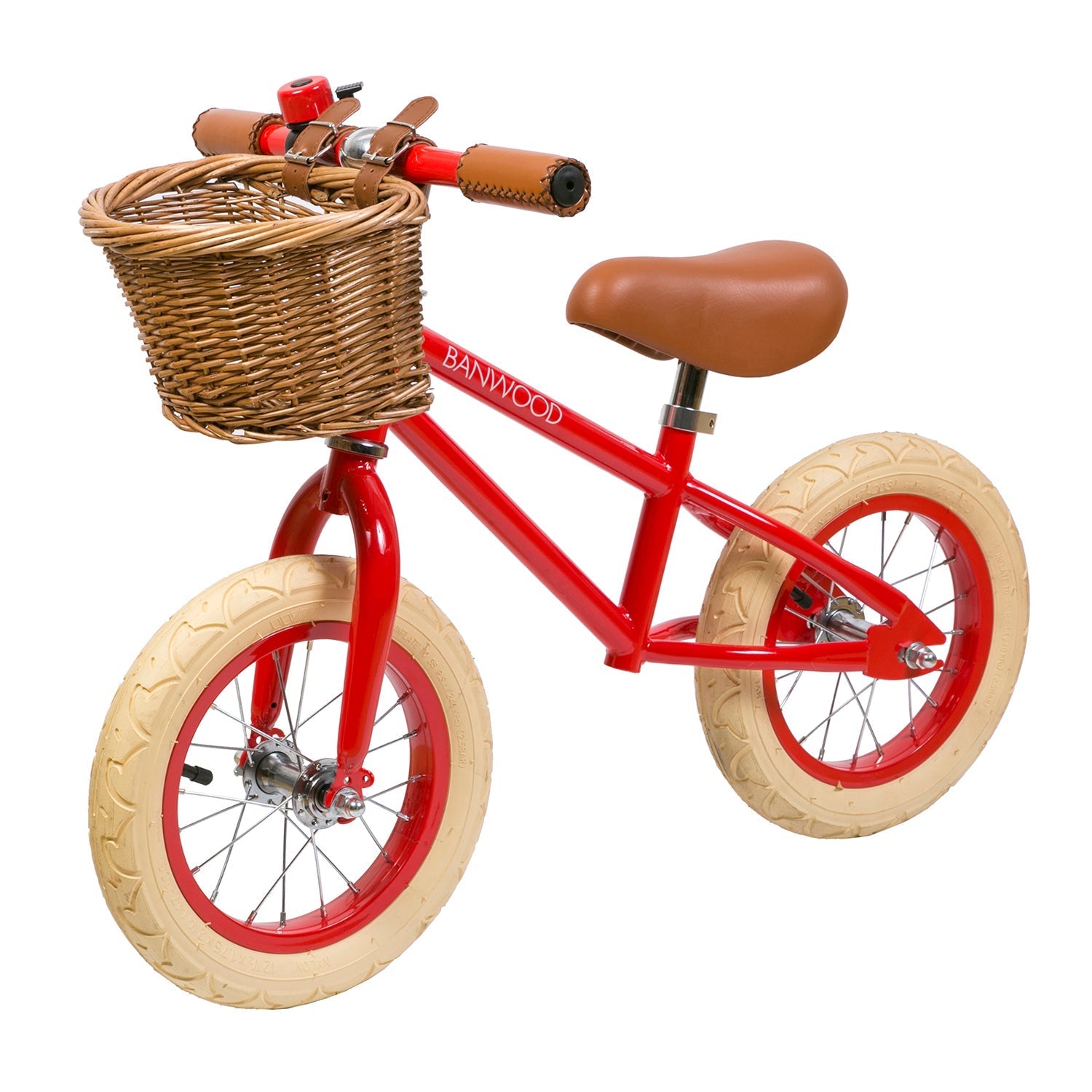 The Banwood - Vintage Balance Bike Red by BANWOOD boasts a vintage style with cream tires, a child-friendly frame, brown leather saddle and handlebars, and a charming wicker basket, complete with a small bell. The brand name is proudly displayed on the frame.