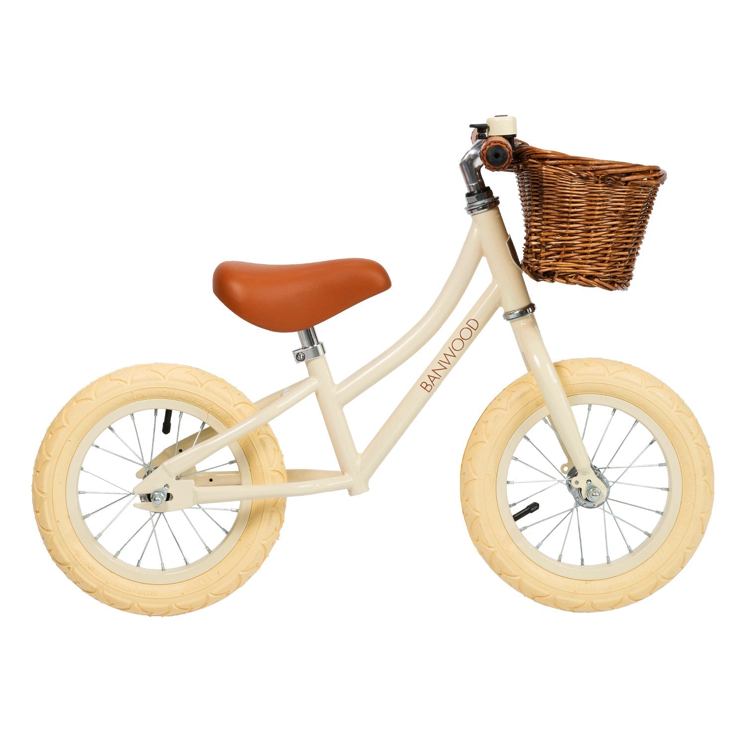 The Banwood - Vintage Balance Bike Cream by BANWOOD features a cream-colored frame, tan tires, and a vegan leather seat. It's child-friendly and includes a charming brown wicker basket for young adventurers.