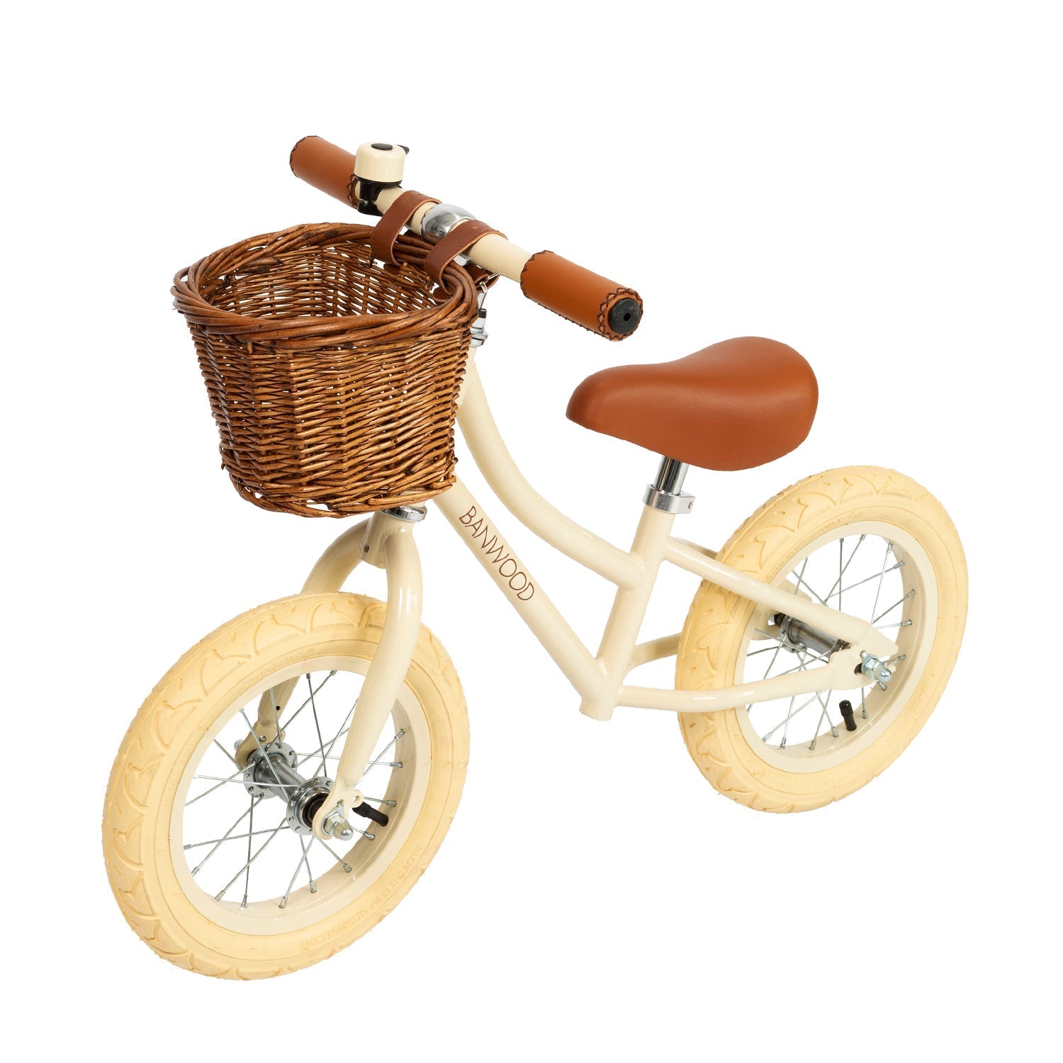The Banwood - Vintage Balance Bike Cream by BANWOOD is a cream-colored bike with light brown handlebars, a matching vegan leather seat, beige wheels, and a wicker basket. It has a simple frame designed for young riders.