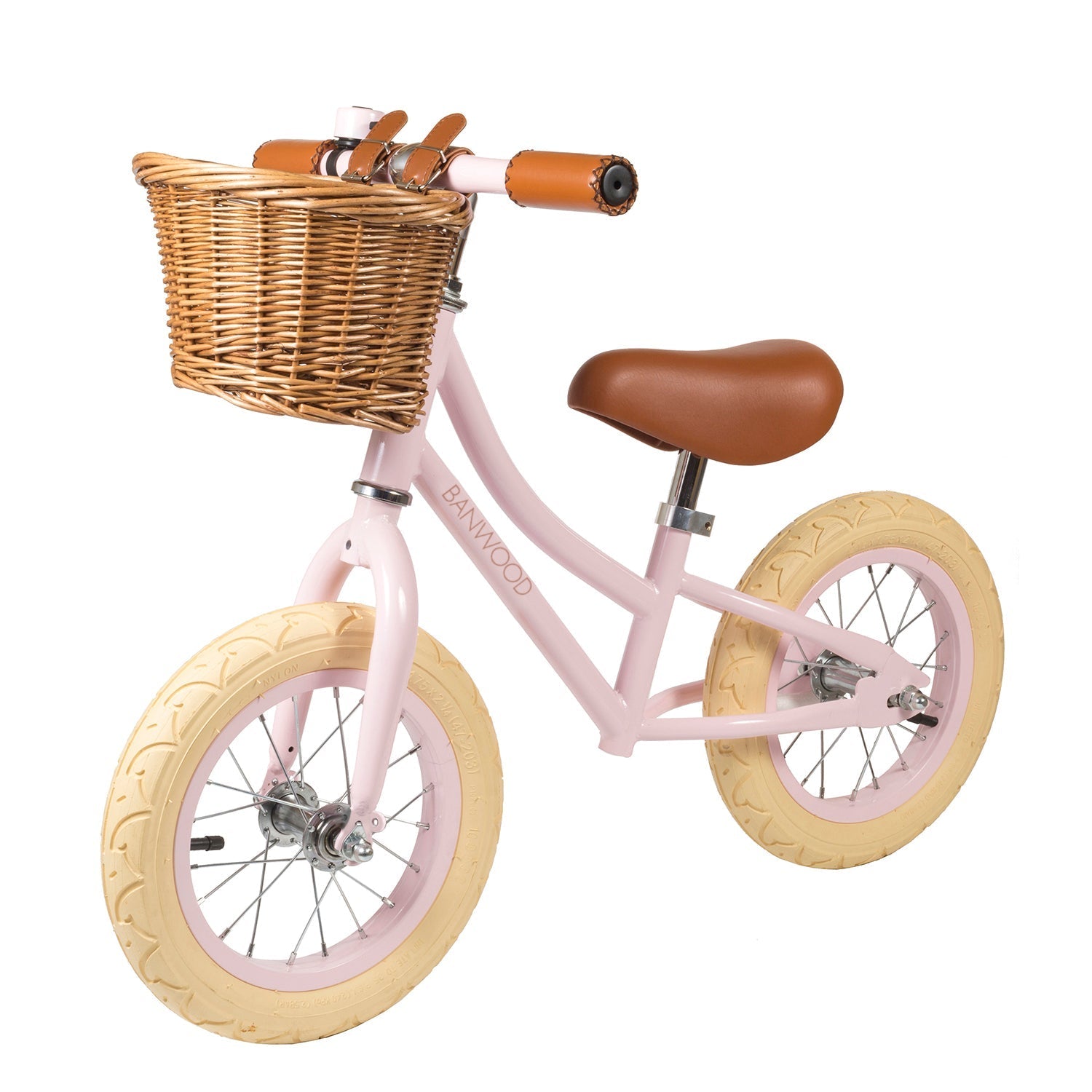 The Banwood Vintage Balance Bike Pink by BANWOOD is a children's balance bike featuring a pink vintage style, wicker basket on the handlebars, a brown vegan leather seat and handles, cream-colored wheels, and a sturdy frame for optimal balance and control.