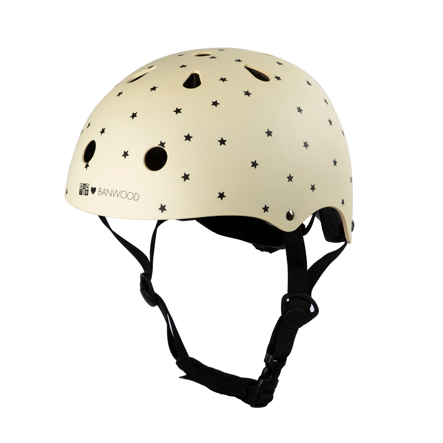 The Banwood - Bonton x Banwood Helmet Cream - S by BANWOOD is a cream-colored children's helmet adorned with black stars. It offers superior protection, featuring adjustable black straps, an adjustable size, and multiple ventilation holes for optimal airflow.