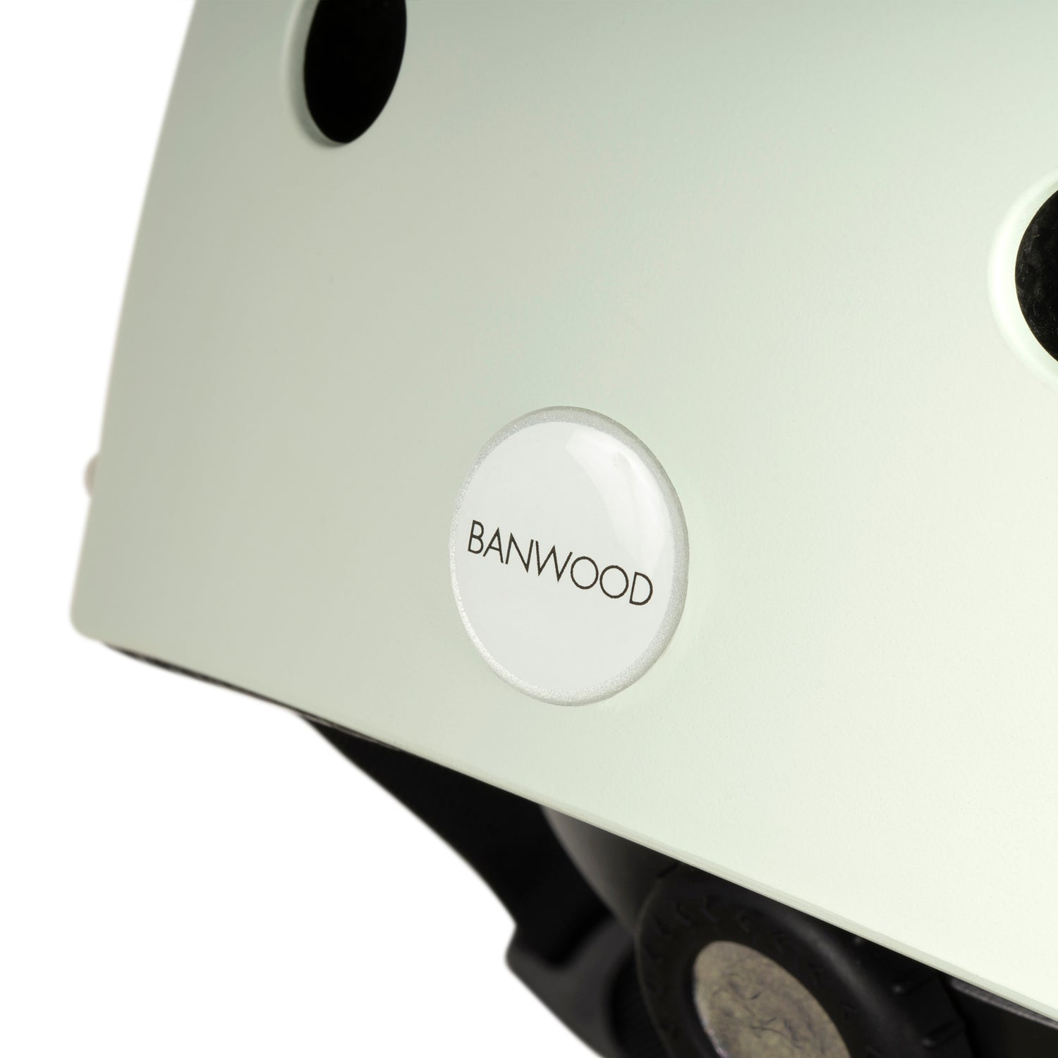 Close-up of a Banwood - Classic Helmet in Pale Mint (XS) showcases the BANWOOD logo on its side. This kids' bike helmet combines safety and style with its simple design and small ventilation holes.