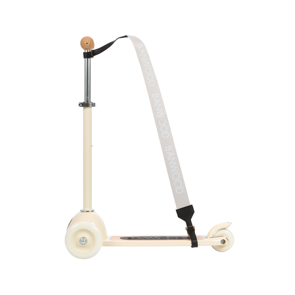 A white kick scooter with a T-shaped handlebar and the Banwood - Carry Strap in cream, branded "BANWOOD." This stylish three-wheel scooter boasts a non-slip deck, ideal for those who value both style and practicality.