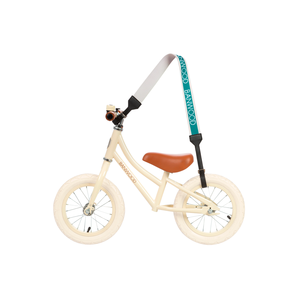 A turquoise frame and handlebars on a cream balance bike with white tires and a brown saddle sport the BANWOOD Carry Strap Green, showcasing the "BANWOOD" brand name.