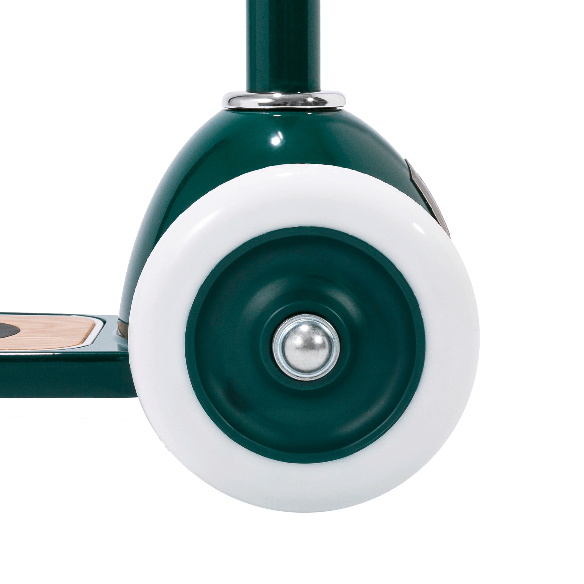 Close-up of a BANWOOD Scooter Green wheel with a white tire and silver axle. The dark green frame has a metallic sheen and features Easy Ride Steering for smooth navigation. A wooden footboard appears in the background, ideal for kids' adventures.