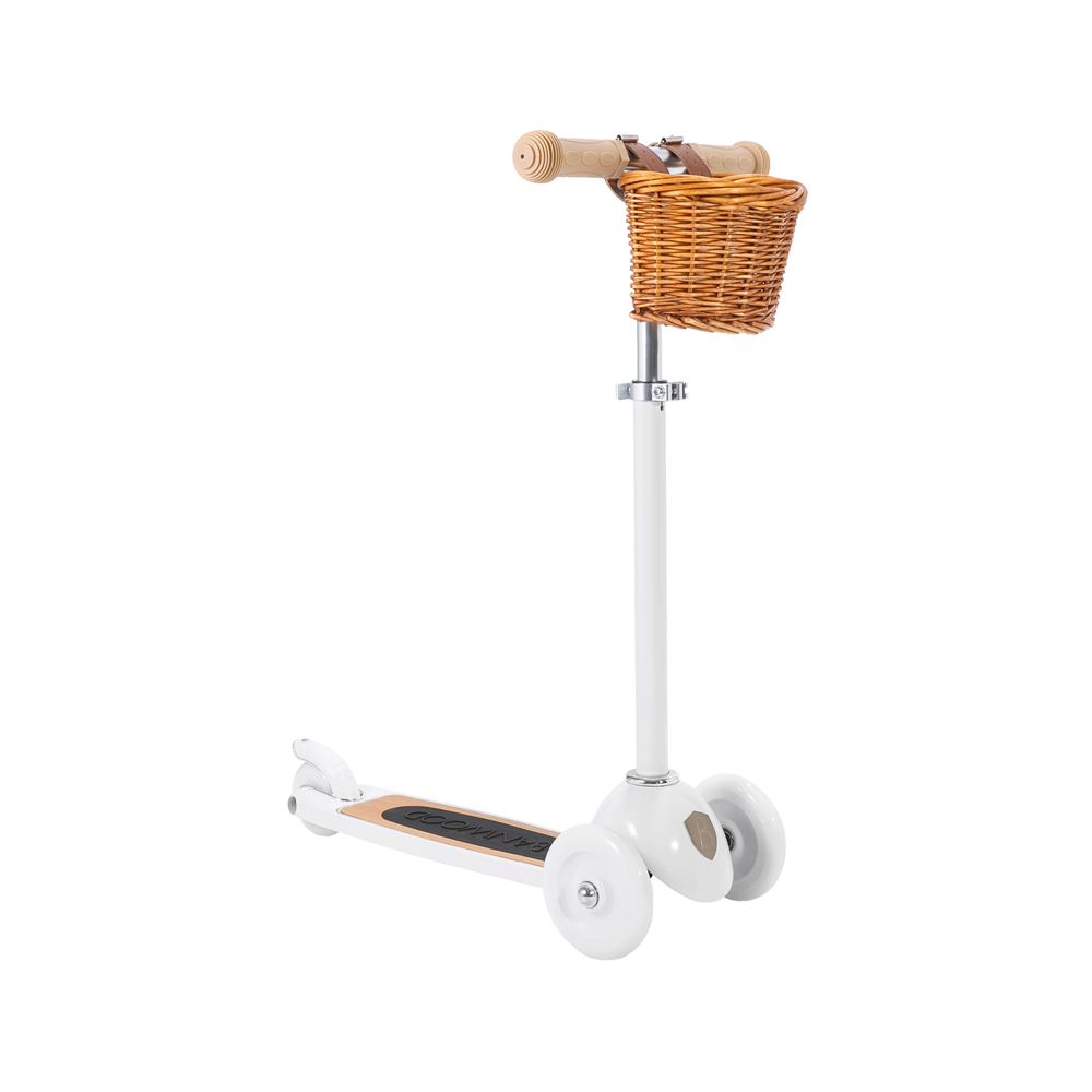 The Banwood - Scooter White is a stylish, retro three-wheeled scooter featuring white wheels, tan handles, and a charming brown wicker basket. Its black footboard and BANWOOD Easy Ride Steering System make it perfect for kids seeking smooth, modern cruising.