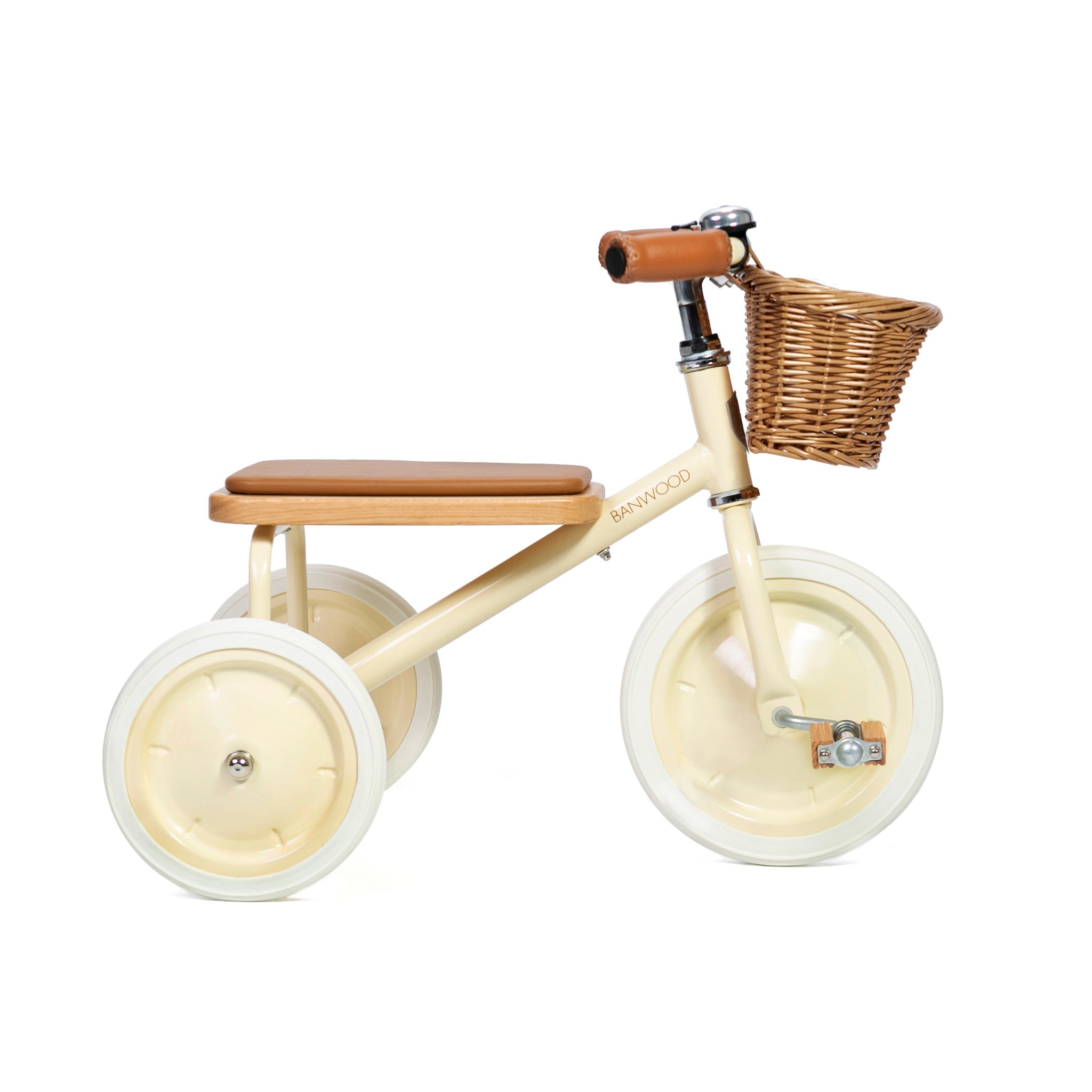 The Banwood - Trike Cream by BANWOOD is a charming beige tricycle with white wheels, a cozy brown seat, and easy-grip handlebars. Perfect for little adventurers, it also features an adorable wicker basket at the front.