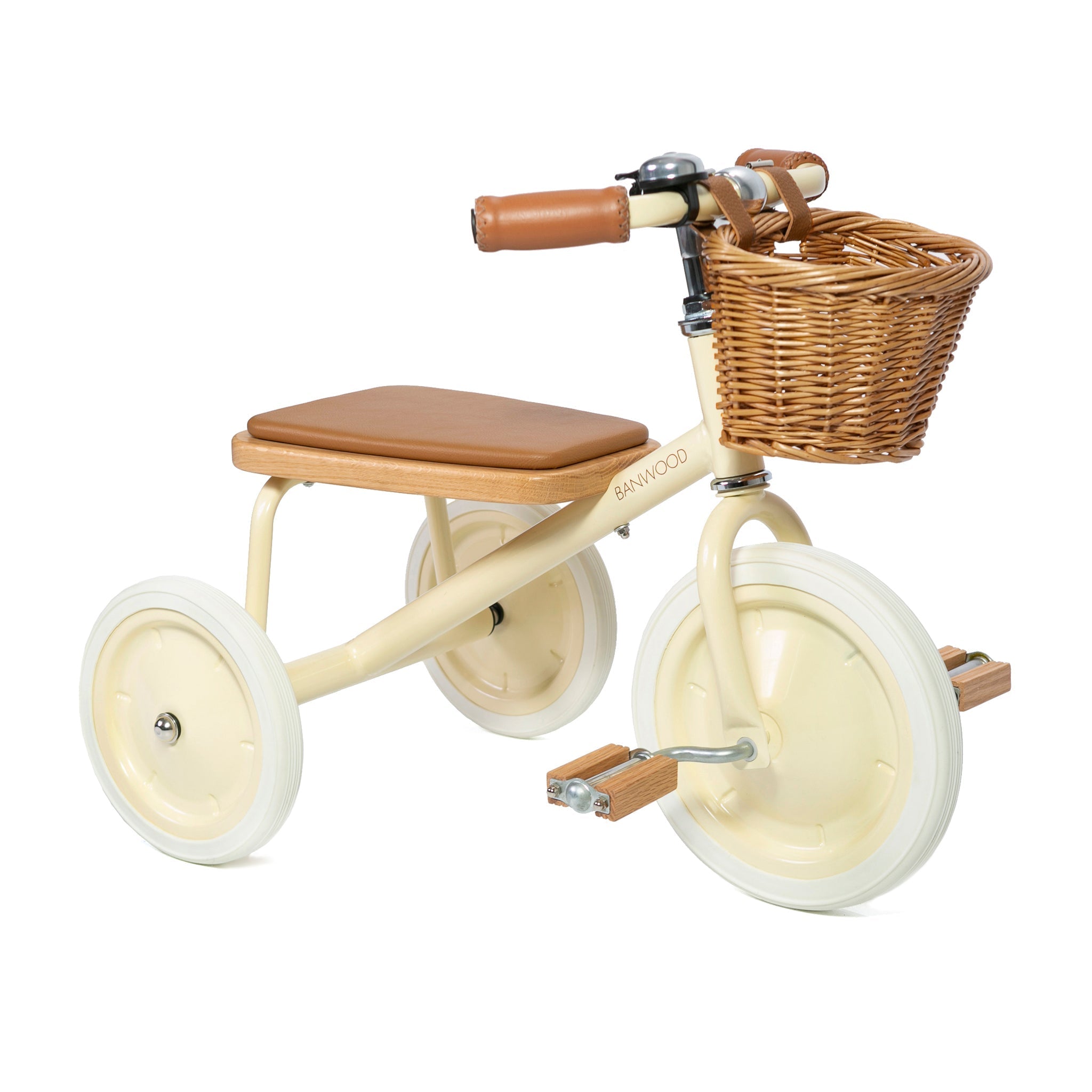 The Banwood - Trike Cream by BANWOOD is a cream-colored baby trike featuring white wheels, a brown seat and handlebars, a charming wicker basket in front, wooden pedals, all set against a plain white background.