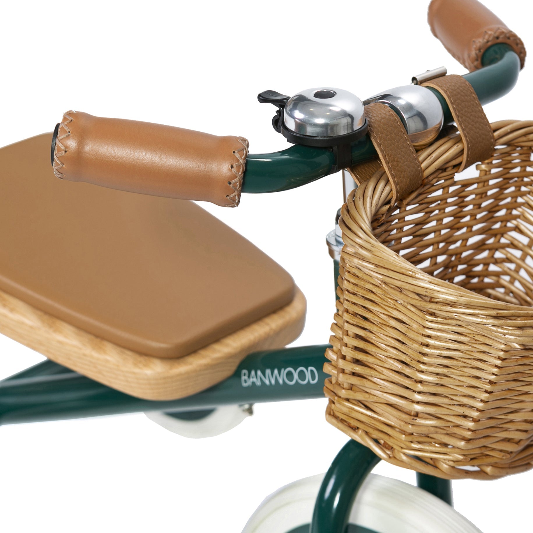 The BANWOOD "Banwood - Trike Green" is a children's tricycle with a green frame, featuring a front wicker basket on the handlebars, a bell and brown leather handles, paired with a brown leather seat.