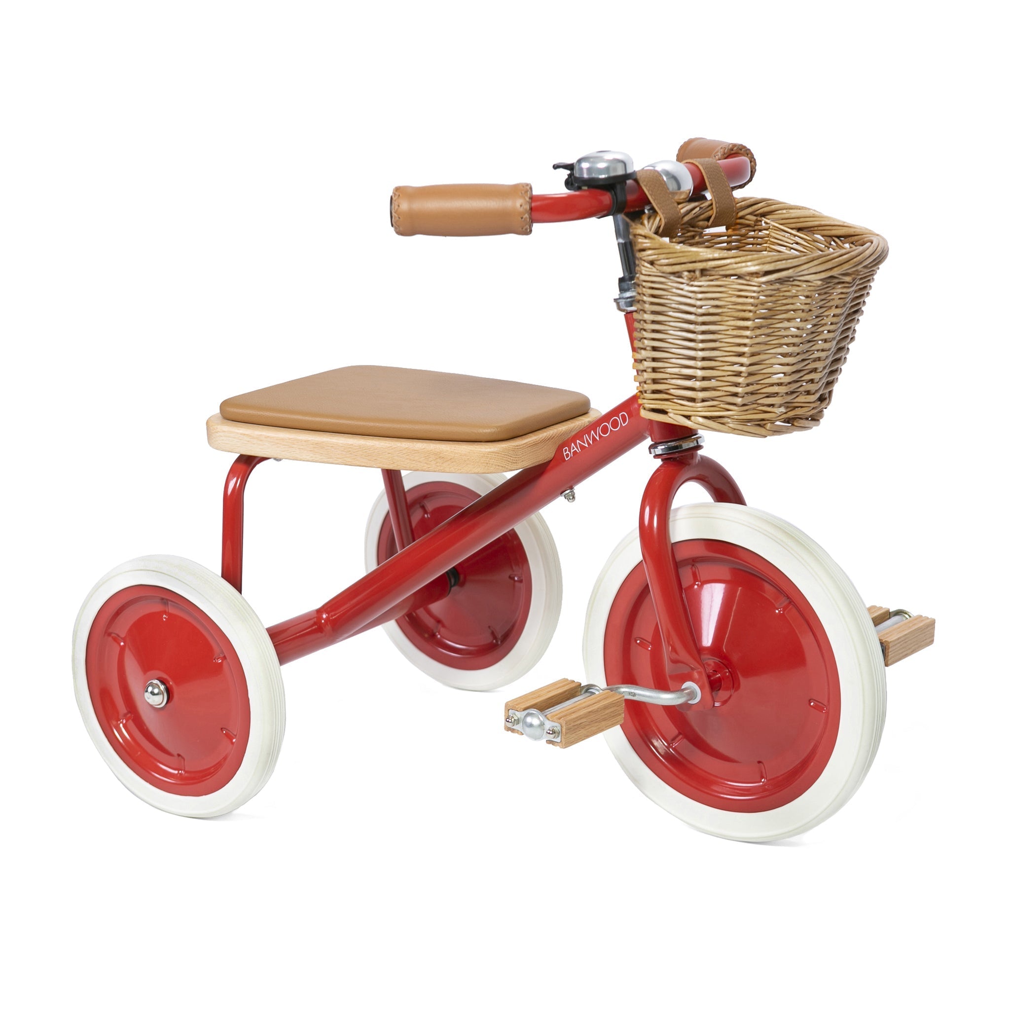 The Banwood - Trike Red from BANWOOD boasts white wheels, a wooden seat and pedals, a charming brown wicker basket on the handlebars, brown grips, and a sparkling silver bell—a delightful ride for kids.