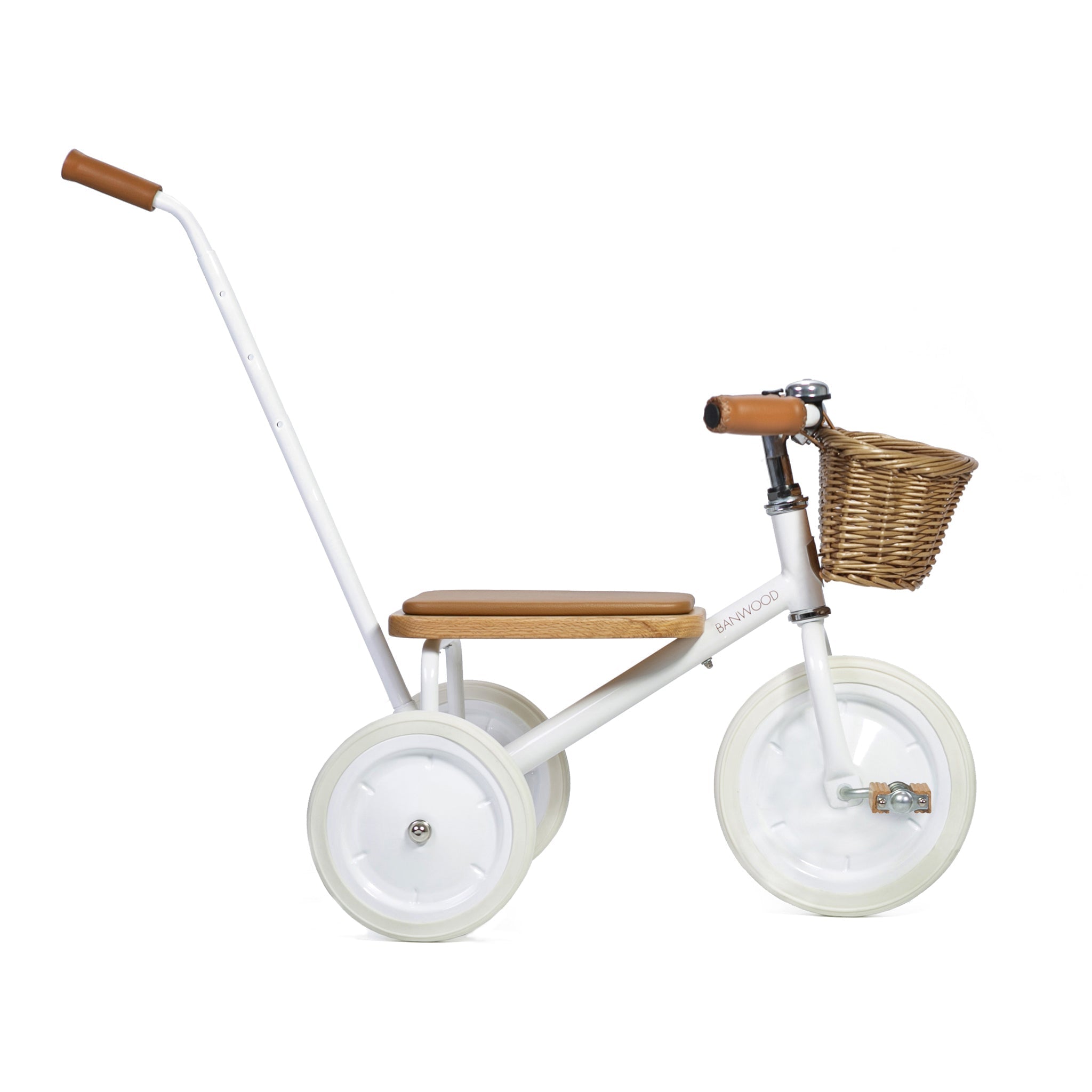 The Banwood - Trike White by BANWOOD is a minimalist tricycle for kids, boasting a white frame, wooden seat and handlebars, three white wheels, and a front wicker basket. It also includes a detachable push handle for convenience.
