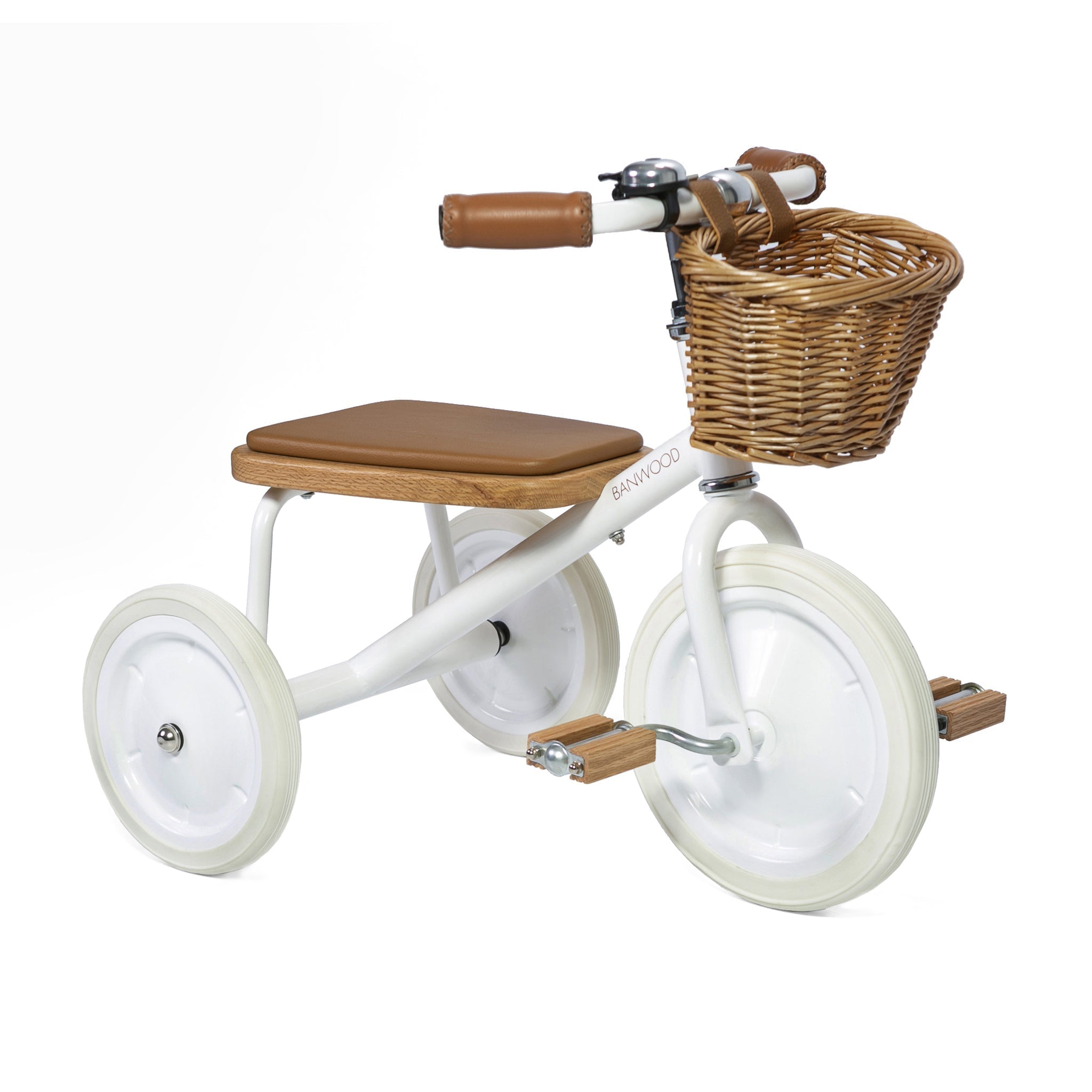 The Banwood - Trike White by BANWOOD is a vintage-style kids' tricycle with white pedals and tires, a brown seat and handlebar grips, a wicker front basket, and a detachable push handle for easy guidance.