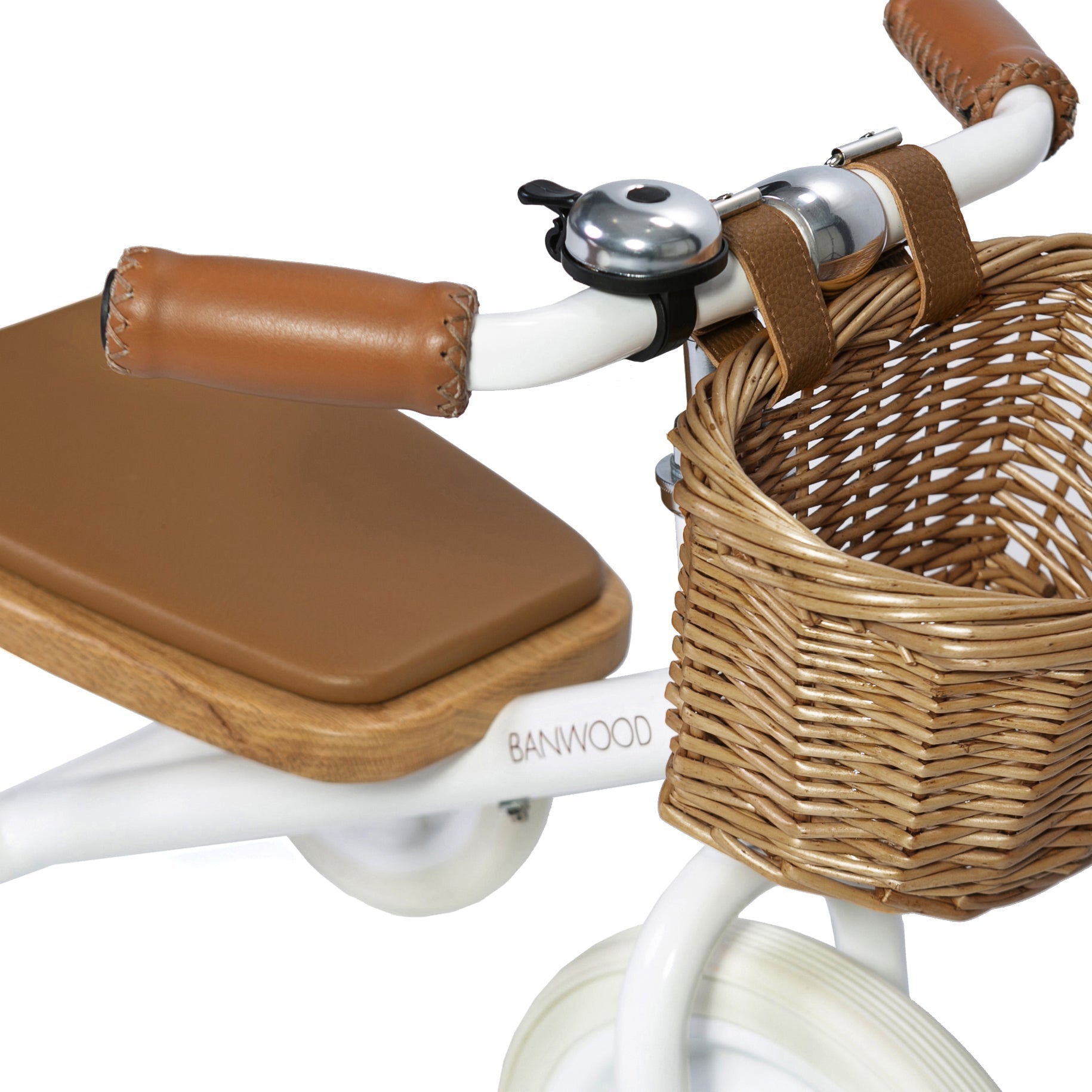 A close-up of the BANWOOD Trike White shows brown leather handles, a wicker basket, a brown seat, and a white frame. It's equipped with a detachable push handle and features a small silver bell on the handlebar for easy maneuvering.