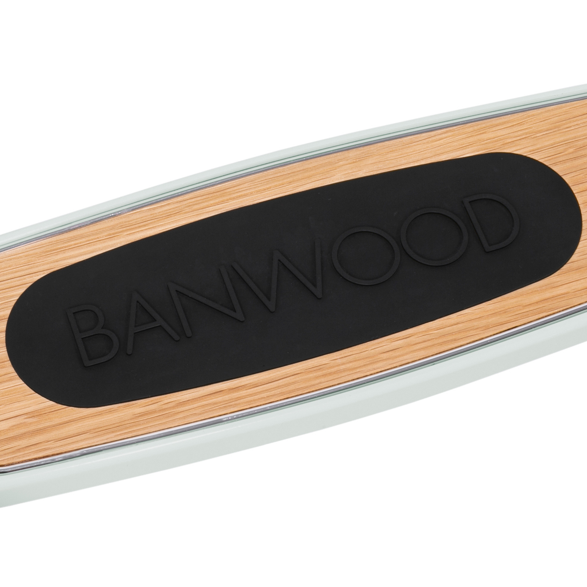 Close-up of a skateboard deck with a wooden finish and black rubber grip, embossed "BANWOOD." White edges enhance its sleek look. Pair it with the Banwood - Scooter Mint featuring an Easy Ride Steering System for smooth control to improve balance and coordination.