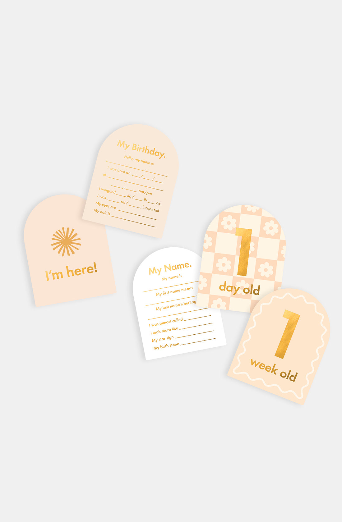 Five Fox & Fallow - Baby Milestone Cards Helios from FOX & FALLOW are displayed on a light background. Designs include "I'm here!" and "My Birthday" in gold and peach, ideal for birth announcement cards.