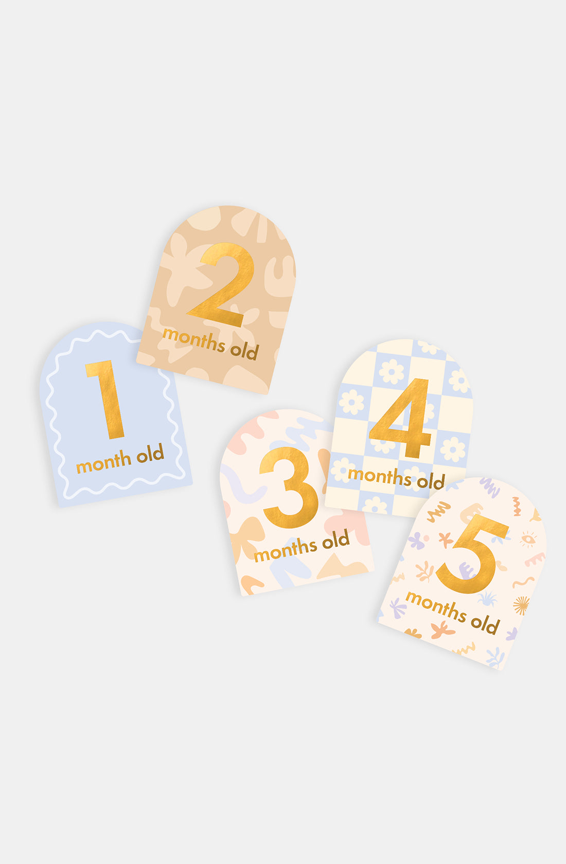FOX & FALLOW's Baby Milestone Cards Helios features five pastel milestone cards with gold “1 month old” to “5 months old” text, perfect for documenting your baby’s growth and special moments.