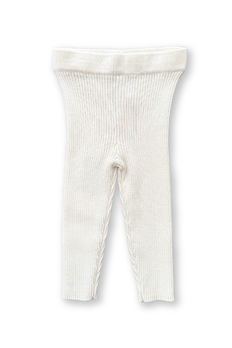 The GROWN Organic Ribbed Essential Leggings in white are mini, footless baby leggings crafted from soft, stretchy GOTS certified organic cotton. They feature an elastic waistband for comfort and warmth, with the product image isolated on a white background.