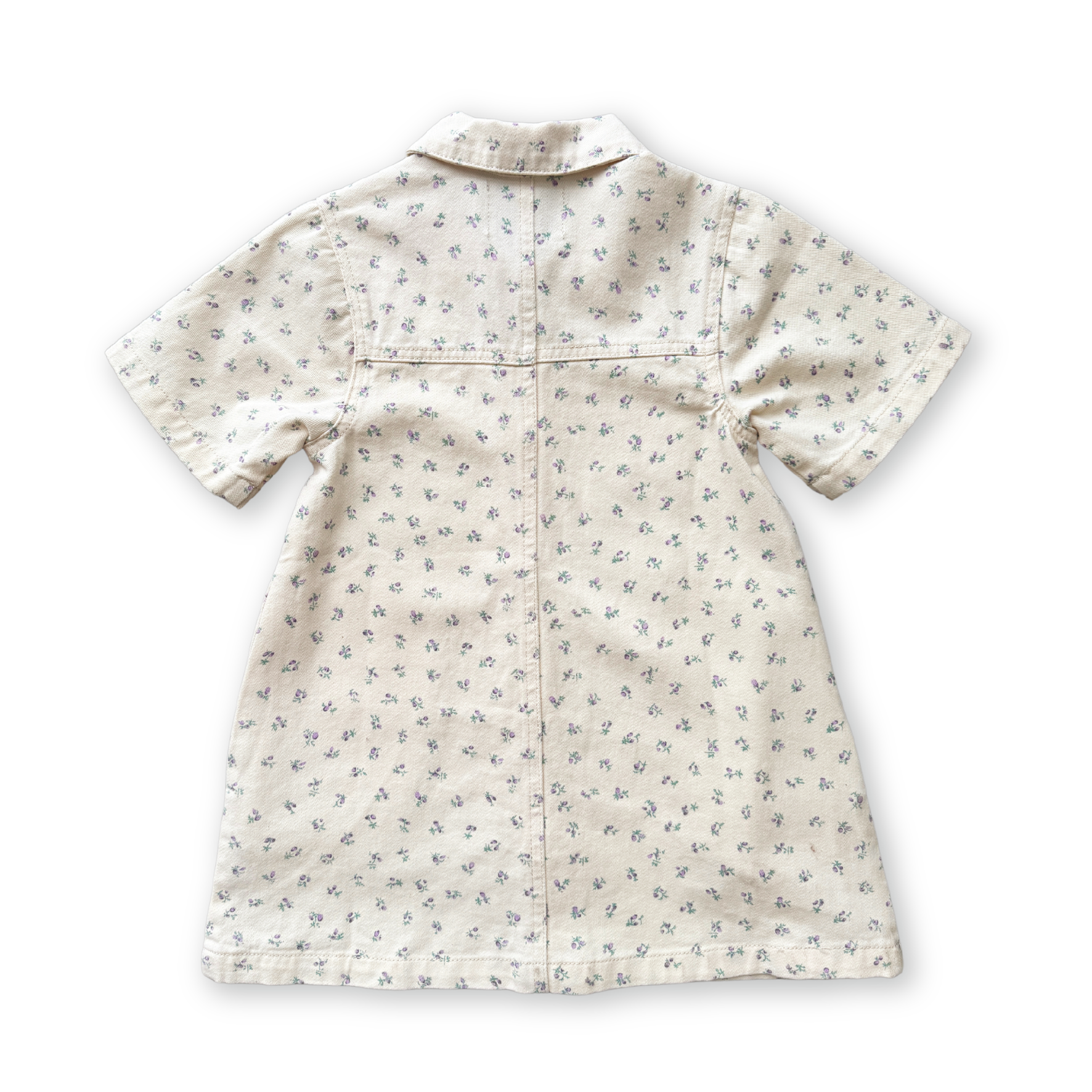 The GROWN - Collar Dress Garden by GROWN is a short-sleeved, 100% cotton dress with a small floral print, collar detail, and seam accents on the back. It is shown laid flat with the back side visible.