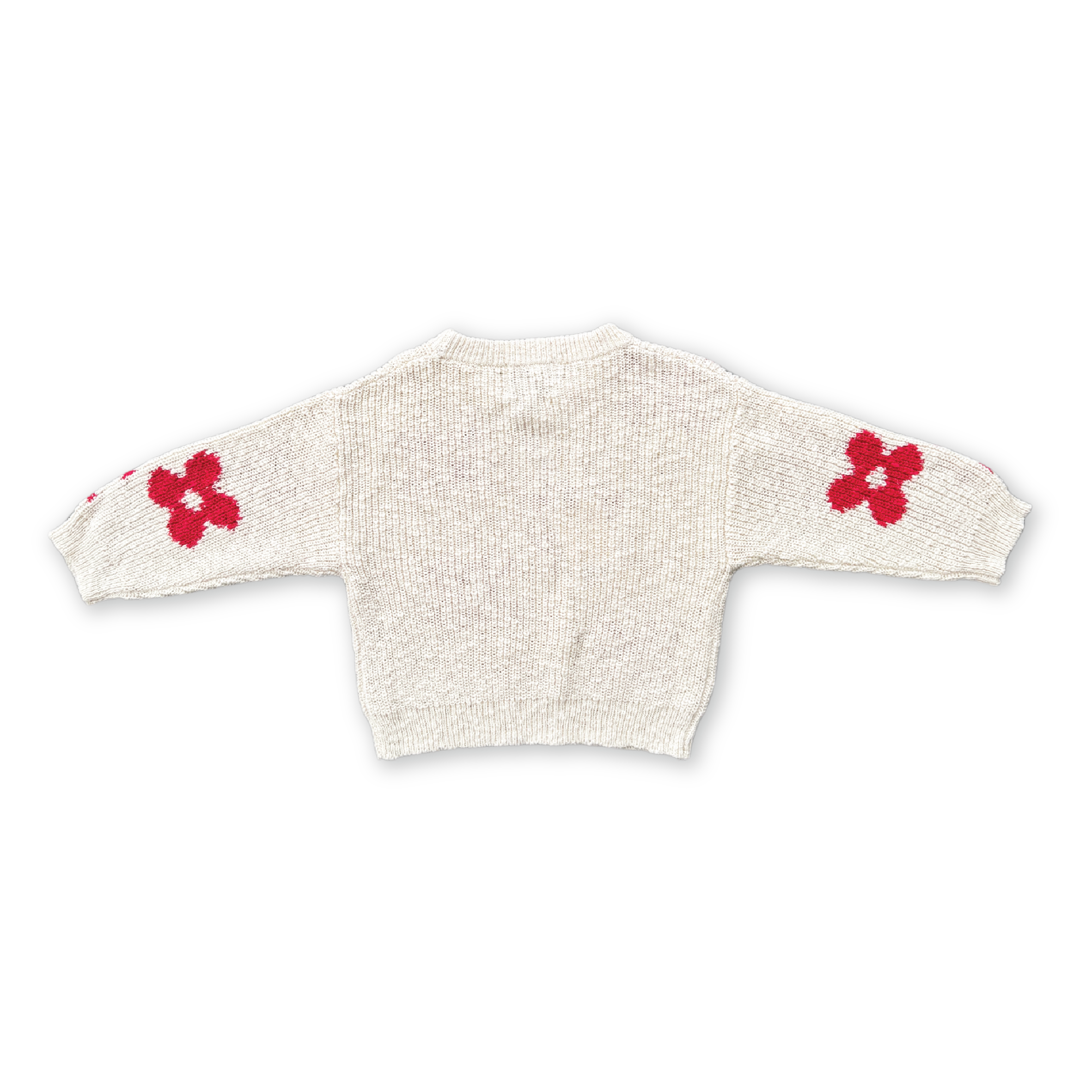 The GROWN Knitted Posy Pull Over is a light beige organic cotton sweater with long sleeves and bold red posy flower patterns on each sleeve, shown flat against a black background.