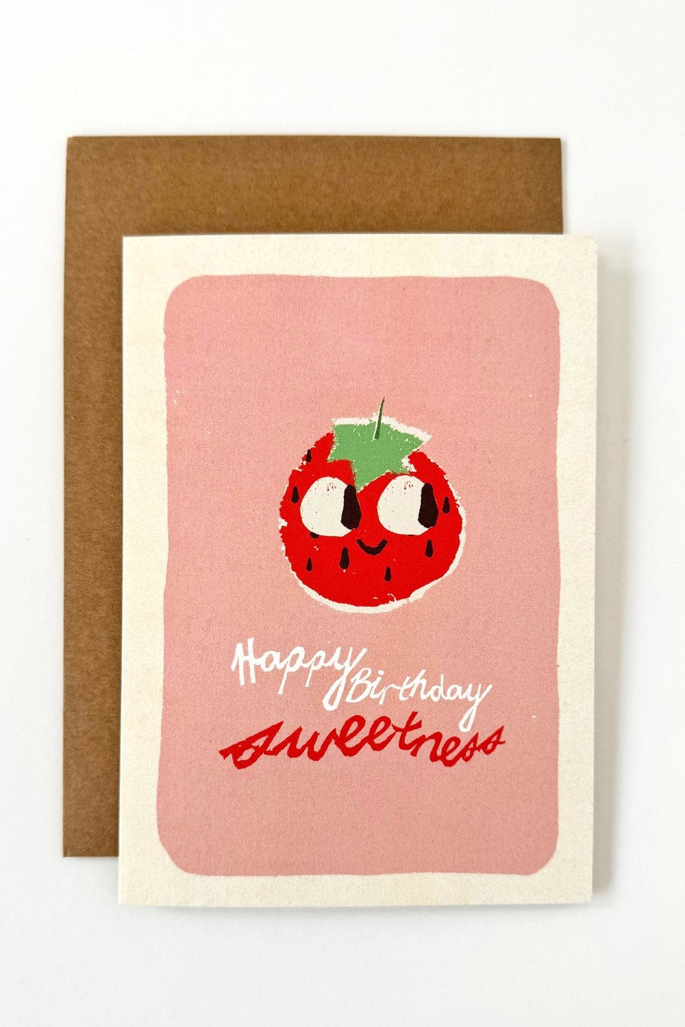 The Florence Fry - Birthday Greeting Card "Happy Birthday Sweetness" by FLORENCE FRY features a smiling strawberry on pink, printed on FSC paper with a recycled Kraft envelope—an eco-friendly choice for birthday wishes.