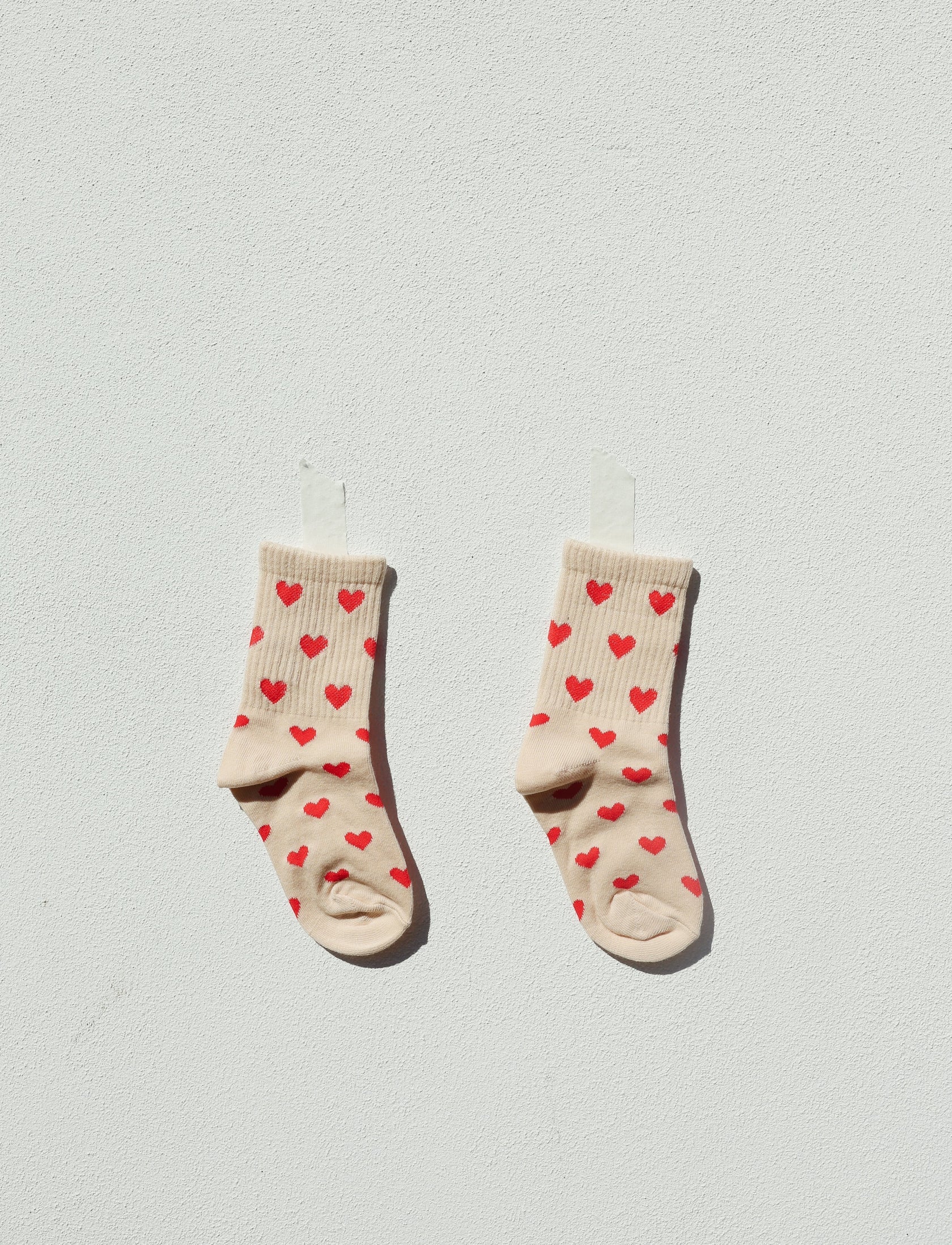 The all heart sock in beige with red hearts.