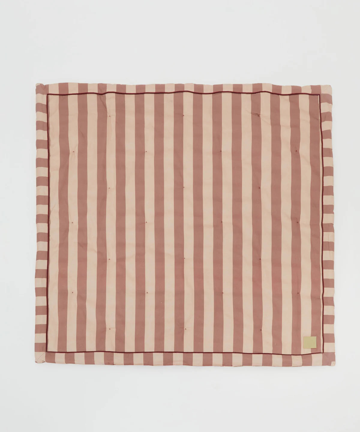 The PHILÉ Philé - Striped Play Mat Pink is an eco-friendly rectangular play mat made from OEKO-TEX cotton, featuring quilted vertical dusty pink and beige stripes with a matching border, shown flat on a white background.