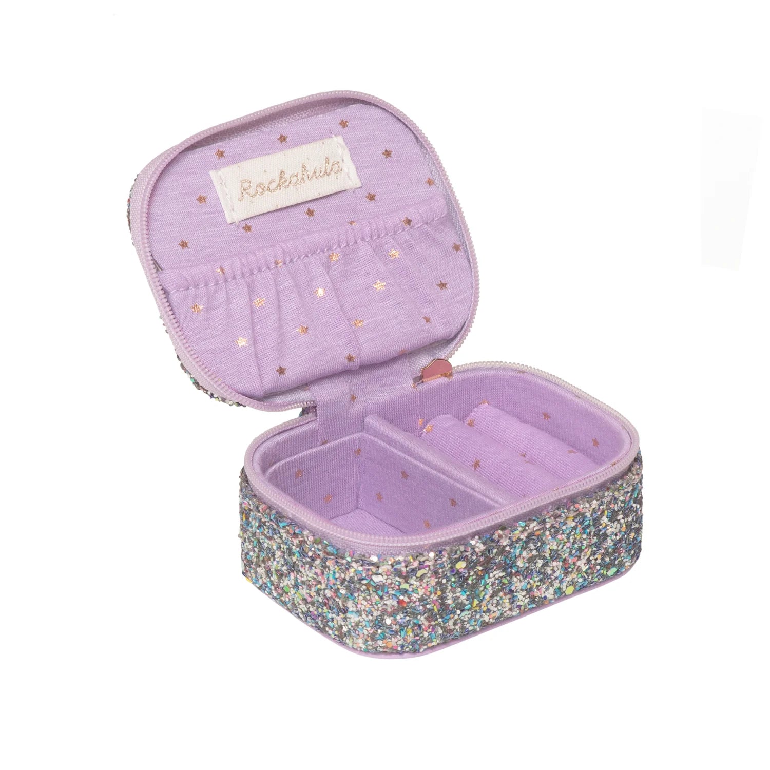 The ROCKAHULA Lilac Confetti Glitter Mini Jewellery Box features a sparkling rectangular exterior, inner compartments for jewellery, gold star details, and a fabric label on the lid—all crafted from recycled fabric.