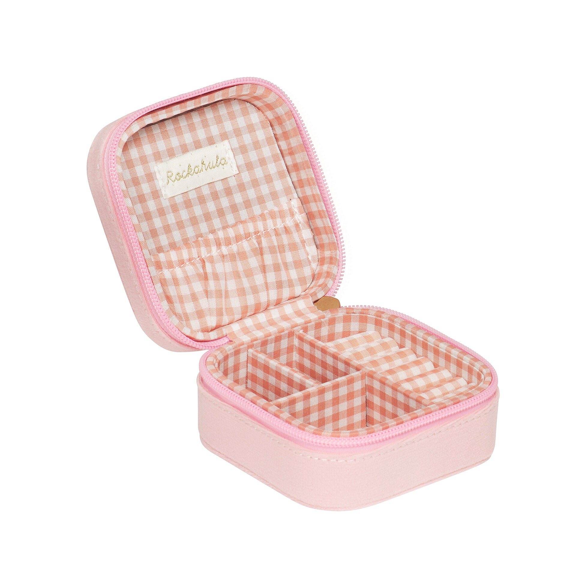 The ROCKAHULA Rockahula - Sweet Strawberry Square Jewellery Box is a small, square, pink velvet box with a zipper, featuring a peach and white gingham fabric interior, multiple compartments, and elastic pockets inside the lid.