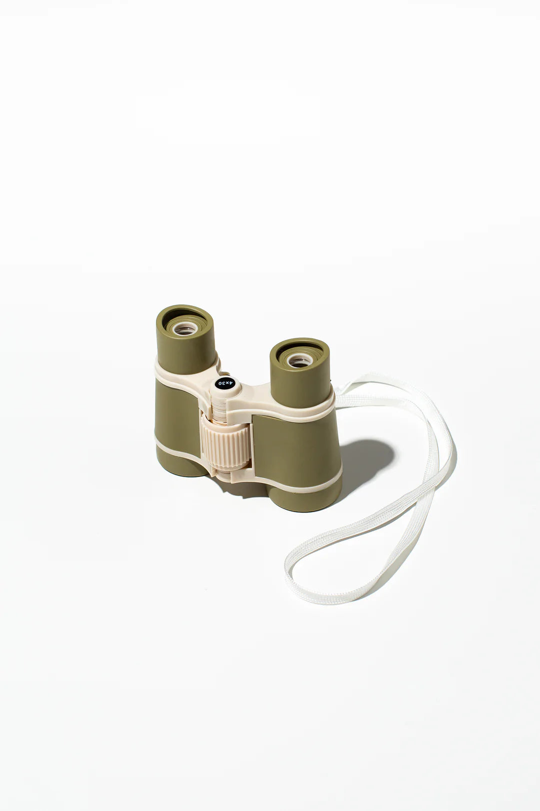 A pair of the Kids Explore Binoculars Moss by LITTLE DROP, featuring a compact design with a green and beige casing and a white adjustable strap on one side, is set against a plain white background. These binoculars include a central focus wheel and are designed for lightweight portability—perfect for your next scavenger hunt.