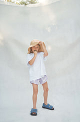 Girl in crochet hat eating an icy pole wearing the Fun Guys tee with lilac gingham shorts
