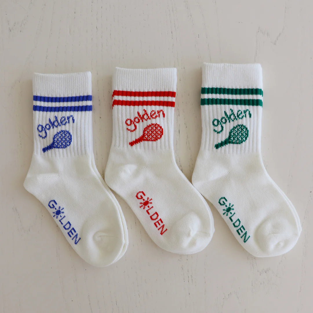 Three pairs of GOLDEN CHILDREN Retro Boy Socks (Vanilla/Green) are showcased, each with a sporty design featuring red, blue, and green tennis rackets and "GOLDEN" text. The "GOLDEN" logo is printed on the foot in matching colors, with reinforced toe caps for added durability.