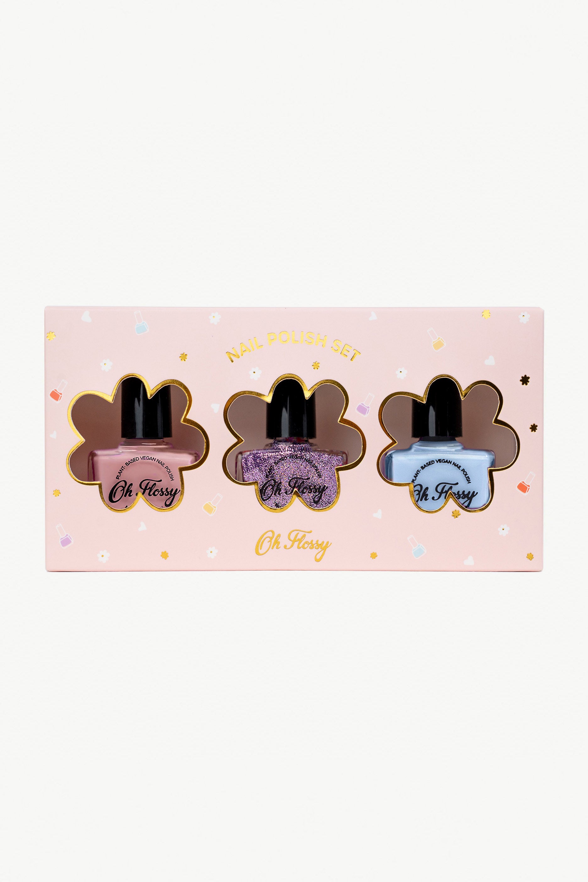 The Oh Flossy ~ Storytime Nail Polish Set by OH FLOSSY includes three plant-based kids polishes—pastel pink, glittery purple, and pastel blue—in a pink flower-shaped box with a window labeled "Oh K!" Decorated with flowers and stars for charm.