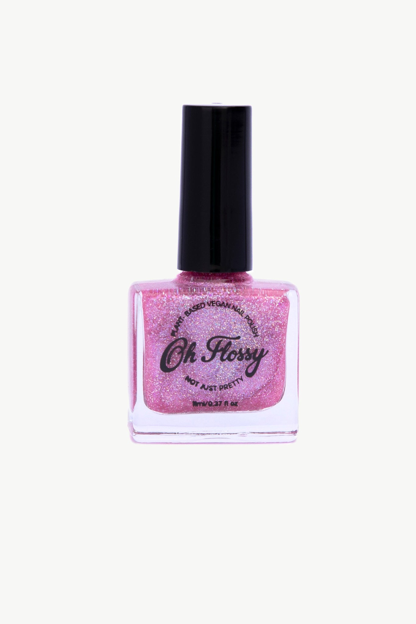 The "Oh Flossy ~ Nail Polish Pink Glitter" by OH FLOSSY is a vegan-friendly, plant-based nail polish for kids in a transparent square bottle with a black cap and contrasting label, showcasing the playful pink glitter inside.